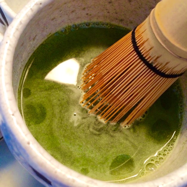 Whisking ground matcha in a modern raku chawan